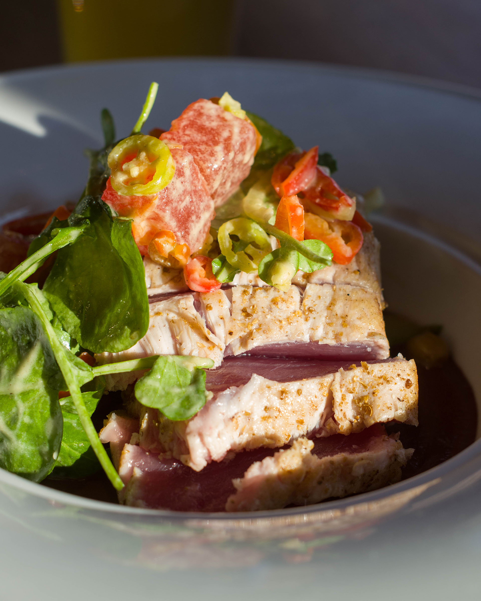 Slices of tuna steak with summer salad on top
